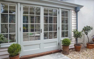 Doors of small conservatory which features work by alasdair Peebles