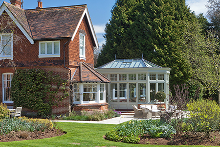 Traditional bay fronted Edwardian conservatory with bifold doors in Surrey
