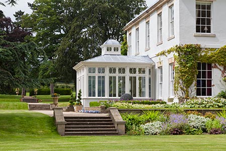 An orangery With cupola features alongside a replacement lean-to