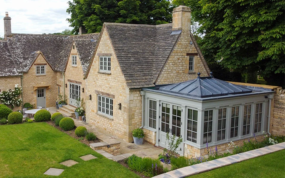 solid roof orangery on an old stone cottage