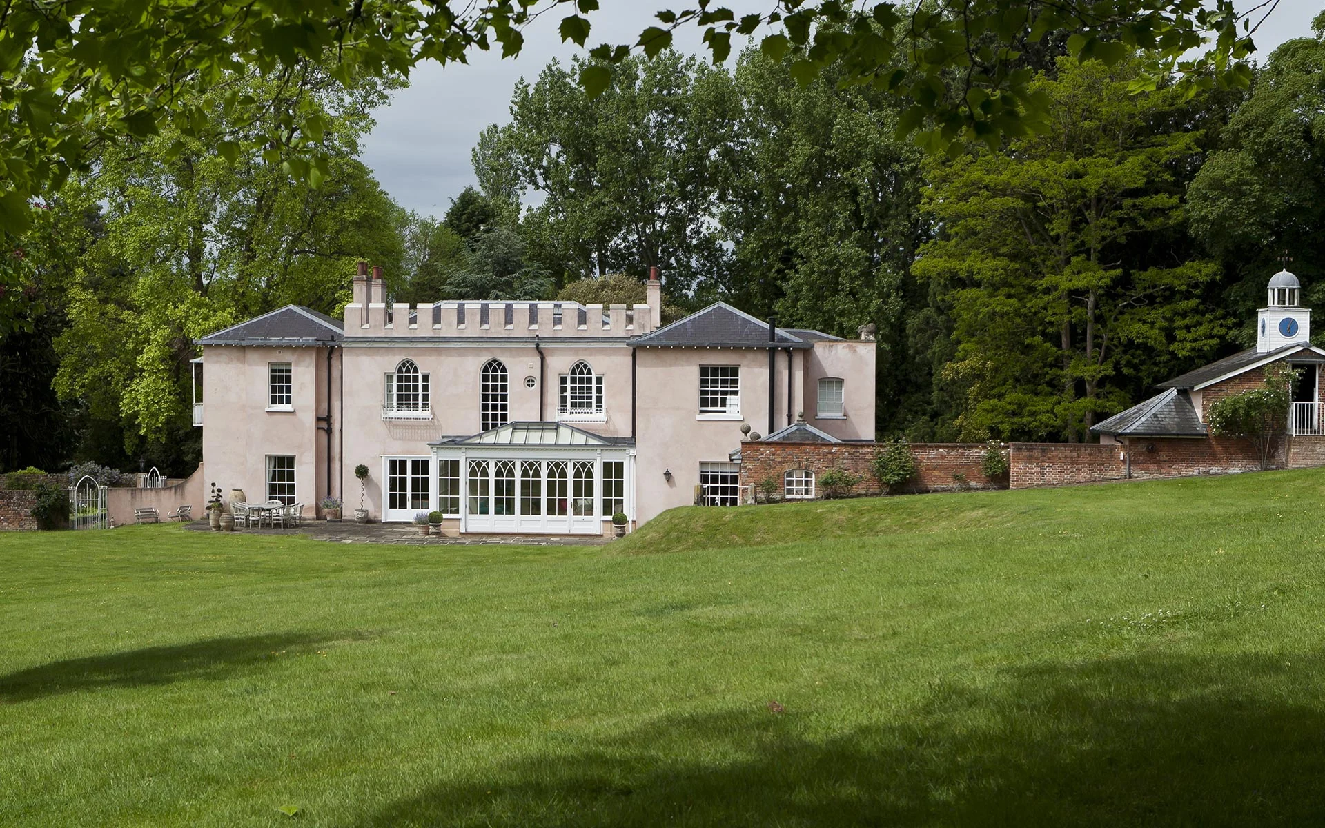 View from the garden of orangery with Gothic arched windows