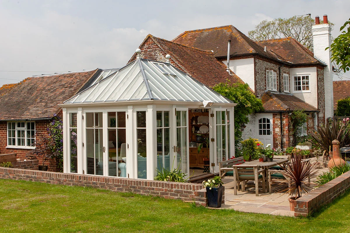 Small square conservatory leading to garden
