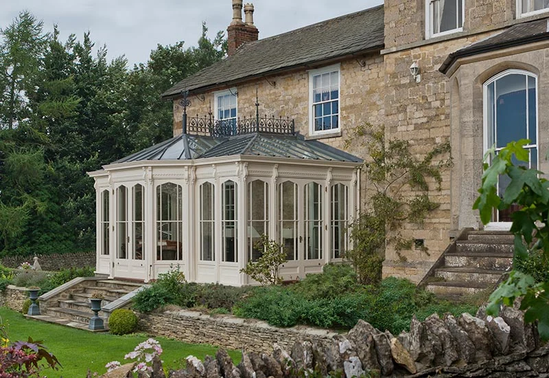 Victorian conservatory design with ornate cast metal crestings